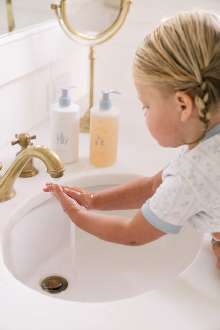 Toddler Washing her hands with soap 